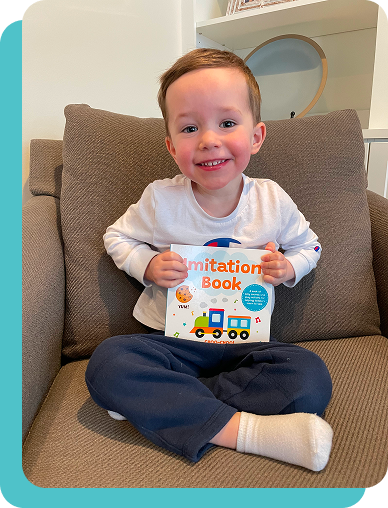 Child Holding Imitation Book.png__PID:71366bcb-5d2e-4b9f-9470-63085d2195d6